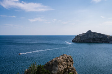 Fototapeta na wymiar Beautiful landscape of Crimea nature. Rocky mountains in the Black sea. Pleasure boats.