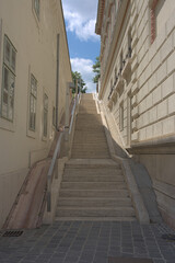 Fototapeta na wymiar European stairs between buildings going up