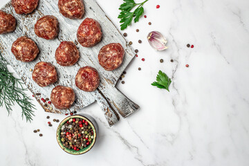 Raw meatballs minced pork meat with spices on a cutting board on a light background, Restaurant menu, dieting, cookbook recipe top view