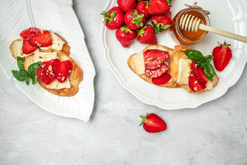 Bruschetta Sandwich with sstrawberries, cheese camembert nuts and honey basil, served as an appetizer