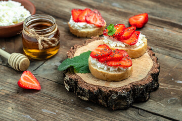 Crostini or toasts with strawberries and cream cheese ricotta. Delicious breakfast or snack, Clean...