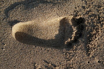 Fototapeta na wymiar footprints on the beach sand taken close up