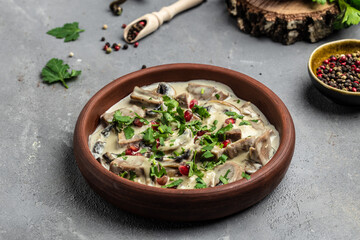 Slow cooked pork stew with mushrooms in creamy sauce served with parsley. Restaurant menu, dieting, cookbook recipe top view