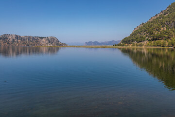 Beautiful nature, sea, mountains and forests. Sunny day. Green trees. Blue colorful sky. A beautiful summer day. Beautiful sea water.
