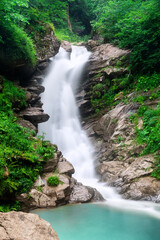  Waterfall cascade on mountain rocks.