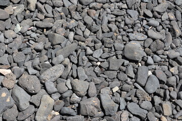 Black lava stones between Boldro and Americano beach, at Fernando de Noronha, Brazil