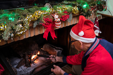 Man lighting fireplace on Christmas day