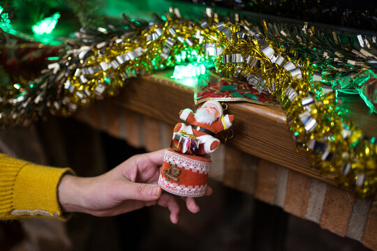 Unrecognizable person decorating fireplace on Christmas day