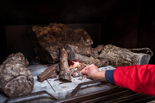 Man lighting fireplace on Christmas day