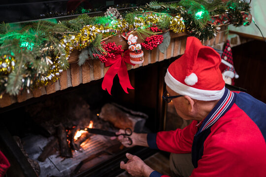Man lighting fireplace on Christmas day