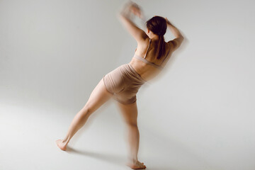 Young woman dancer dancing high heels dance movement with motion blur