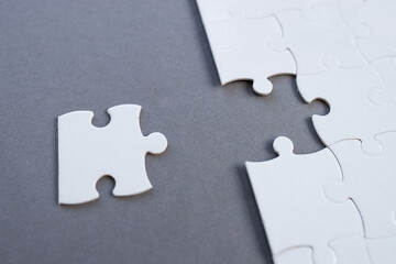 Empty white jigsaw puzzle with missing pieces