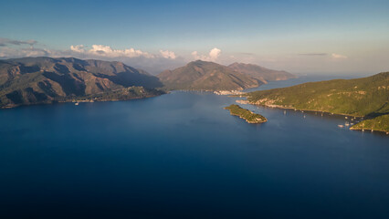 Beautiful seashore. Islands in the distance. Colorful blue sea. The beauty of Turkey. Beautiful rocks and mountains. Sunny clear day. Beautiful water.