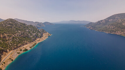 Beautiful seashore. Islands in the distance. Colorful blue sea. The beauty of Turkey. Beautiful rocks and mountains. Sunny clear day. Beautiful water.