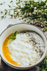 Breakfast of porridge, chia seed and mango puree