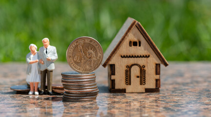 American coins, a figurine of an elderly couple and a symbolic house