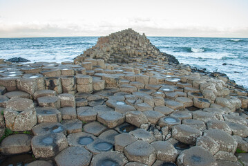 The view of the Honeycomb columns of the Giant's Causeway natural wonder and the Atlantic coast in...