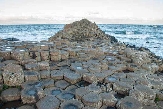 The view of the Honeycomb columns of the Giant's Causeway natural wonder and the Atlantic coast in County Antrim on the north coast of Northern Ireland, UK