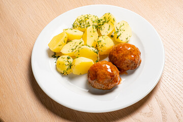 cutlet with baked potato on wooden background