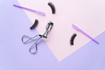 Creative concept beauty fashion photo of lashes extensions brush on pink yellow background.