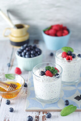 Greek yogurt in glasses with berries and quinoa