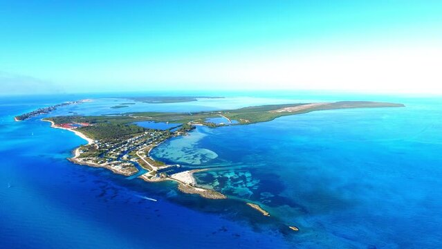 Aerial Upward Idyllic Shot Of Island On Blue Sea Against Sky - Bimini, The Bahamas