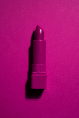 Creative concept beauty fashion photo of lipstick on pink black background.