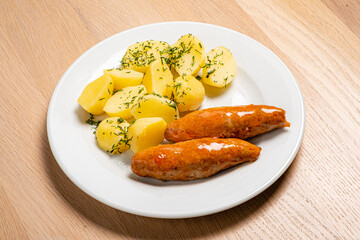 cutlet with baked potato on wooden background