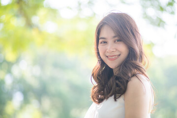 Naklejka premium Pretty asian fashion women relax in green city park sunny day