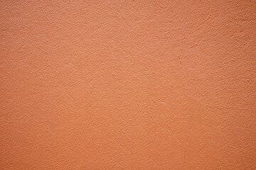 Orange cement wall background in vintage style for graphic design or wallpaper. Pattern of soft concrete floor in retro concept.