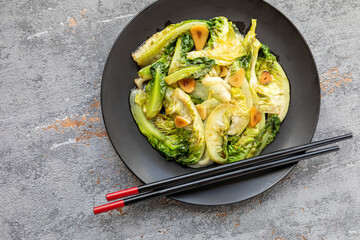 Chinese style stir fry romaine lettuce with garlic and chili, an auspicious dish to serve for Chinese New Year, birthdays and graduations. Lettuce symbolize prosperity and wealth.