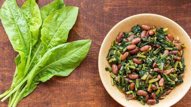 Famous Mediterranean dish with chicory leaves. Italian Cicoria e Fagioli (Chicory and beans). Borlotti beans aka cranberry beans aka rosecoco.