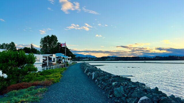 sunset on Ocean Horizon mountains are far visible many clouds and bright colors video suitable for music relaxation background For text silence peace Parksville beach Surfside RV resort 08.2022 Canada