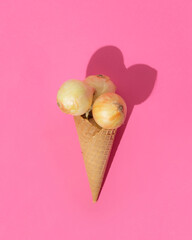  Three whole onions in a waffle cone for ice cream. Fun vegetable concept.