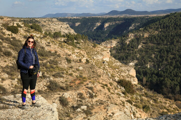 Alcal&aacute; del J&uacute;car, Woman standing in front of the cliff with the valley of the Alcala del Jucar countryside.