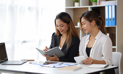 Attractive businesswoman colleagues and financial advisors in the office discuss budget planning. Accountant is discussing finance and accounting.