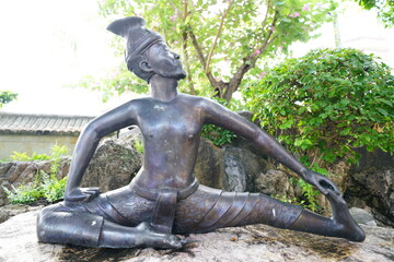 In the area of Wat Pho, Bangkok, Thailand, there are spinning figures showing various postures to...