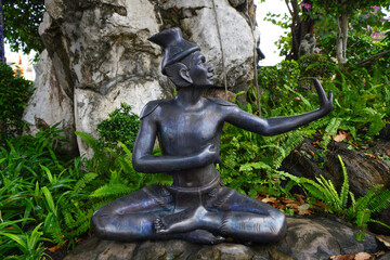 In the area of Wat Pho, Bangkok, Thailand, there are spinning figures showing various postures to...