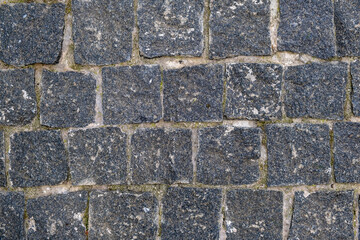 texture, background. The pavement of granite stone. Paved roadway street. any paved area or surface. Old cobblestone road pavement texture
