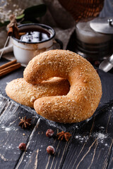 Close up of big sweet bagel on dark rustic wooden table.