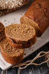 Fototapeta na wymiar Slices of freshly baked traditional brown bread with crispy crust.