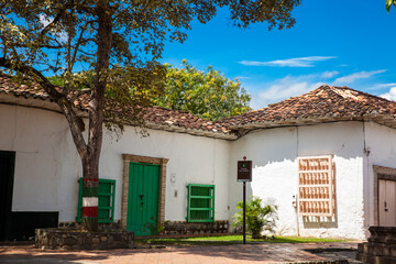 Fototapeta na wymiar Antique houses around the Jesus Nazareno square at the beautiful colonial town of Santa Fe de Antioquia in Colombia