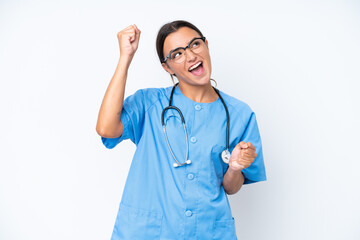 Young nurse woman isolated on white background celebrating a victory