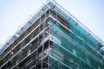 building with scaffolding renovating facade
