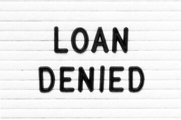 Black color letter in word loan denied on white felt board background