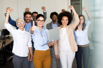 Group of successful multiethnic business people celebrating a good job in the office