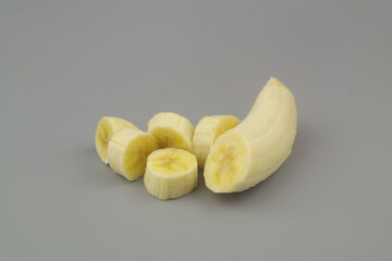 Banana slices on gray background	