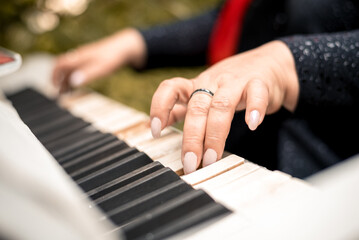 close-up female hands playing the piano