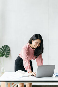 Asian woman working with laptop in her office. business financial concept.