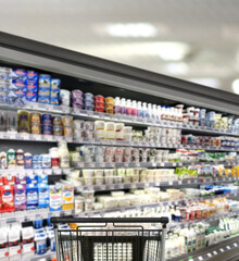 choosing a dairy products at supermarket.empty grocery cart in an empty supermarket